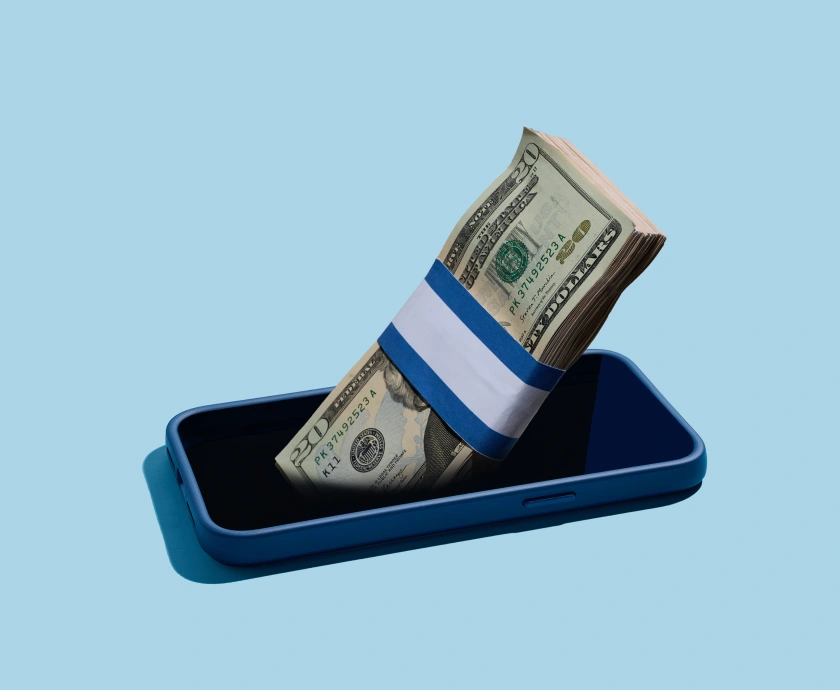 A stack of U.S. dollar bills wrapped with a blue and white band, partially inserted into a blue smartphone case, set against a light blue background.