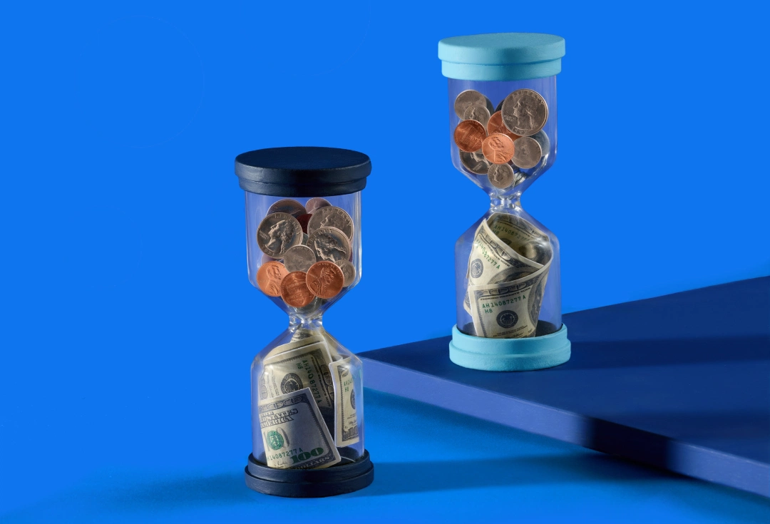 Two hourglasses, filled with U.S. coins and dollar bills, highlight the value of time